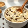 Close-up of homemade cottage cheese cookie dough with chocolate chips in a white ceramic bowl, showing creamy texture and natural ingredients