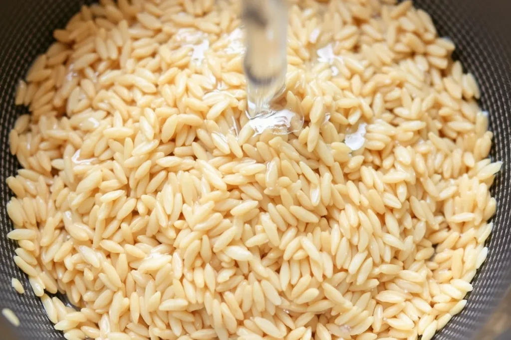 Rinsing short-grain brown rice under cold water to remove excess starch for a fluffier texture.
