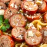 Sliced baked Italian sausages mixed with pasta, olive oil, garlic, and Parmesan cheese for a quick and delicious dinner