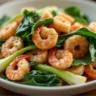 Bok Choy and Shrimp Stir-Fry with garlic, ginger, soy sauce, and sesame oil in a white bowl.