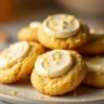 Golden-brown honey buttercream cornbread cookies on a plate with frosting and honey drizzle