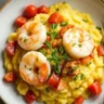 Shrimp Polenta with fresh herbs, Parmesan, and a drizzle of olive oil served in a rustic bowl