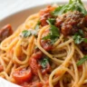 Zesty Mediterranean One-Pot Spaghetti served on a plain white plate, captured in soft natural lighting