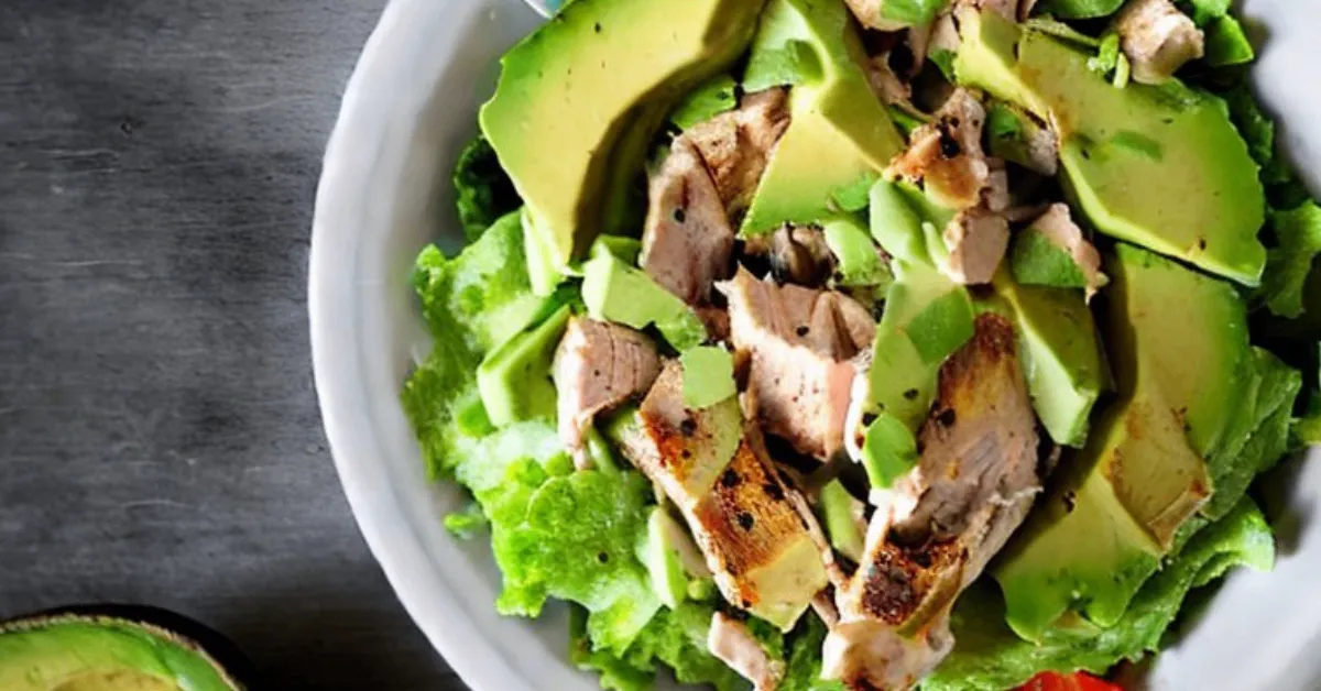 Avocado Chicken Salad with Chipotle and Lime in a white dish, captured with soft natural lighting