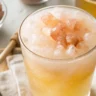 Warm morning detox drink made with lemon, Himalayan pink salt, and honey in a clear glass