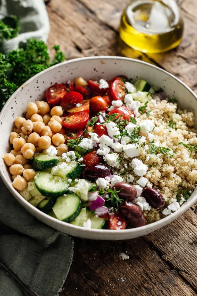 Mediterranean quinoa bowl with chickpeas, cucumber, tomatoes, olives, and feta cheese for weight loss