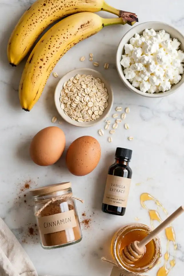 Ingredients for banana oat cottage cheese pancake bites including bananas, cottage cheese, oats, and eggs